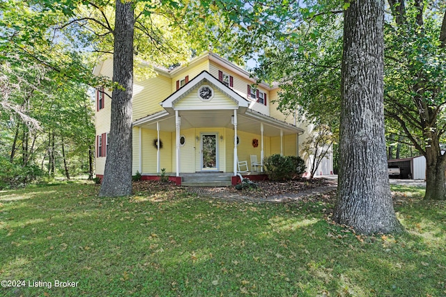 view of front of property with a front yard and covered porch