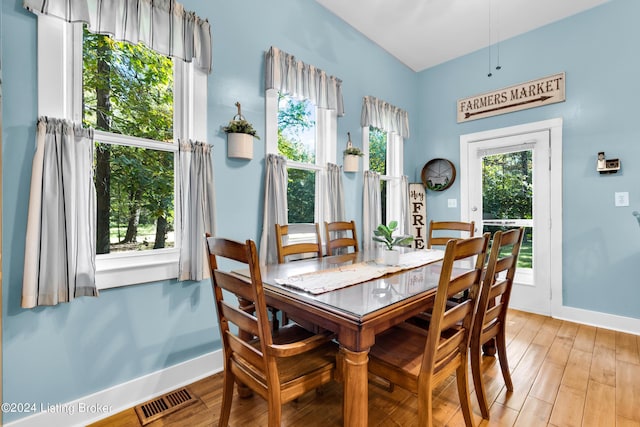 dining room with light wood-style flooring, baseboards, and visible vents