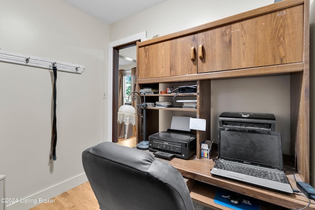 home office featuring light wood-type flooring and baseboards