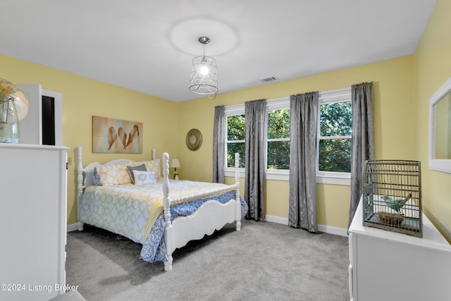 bedroom with visible vents, light colored carpet, and baseboards