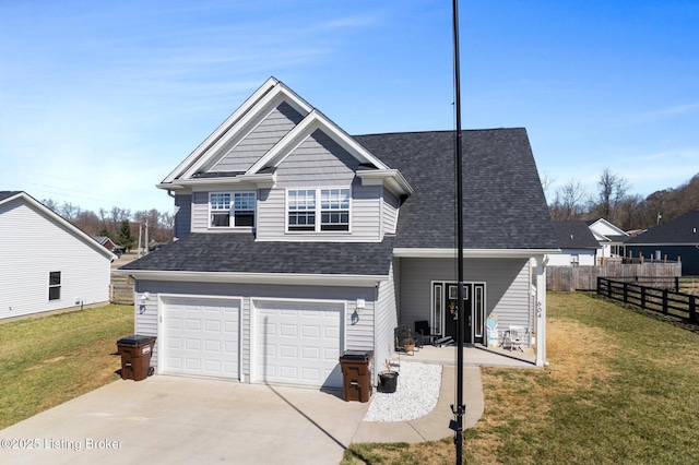 view of front facade with an attached garage, driveway, a front yard, and fence