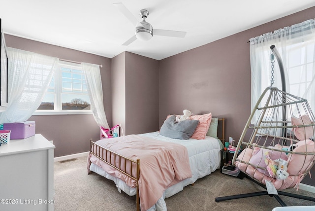 carpeted bedroom featuring a ceiling fan, baseboards, and visible vents