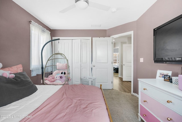 carpeted bedroom featuring a ceiling fan and a closet