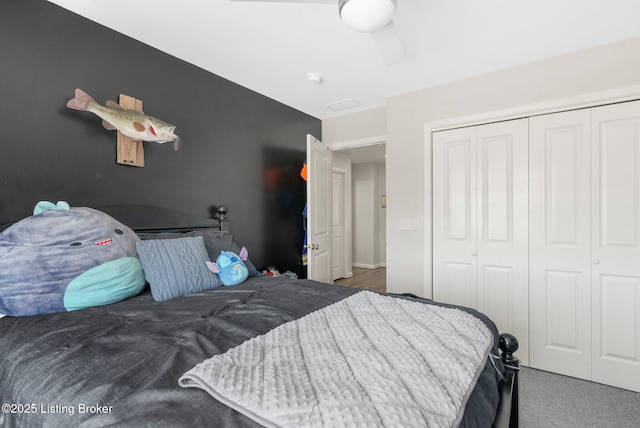 bedroom with a closet, an accent wall, and carpet