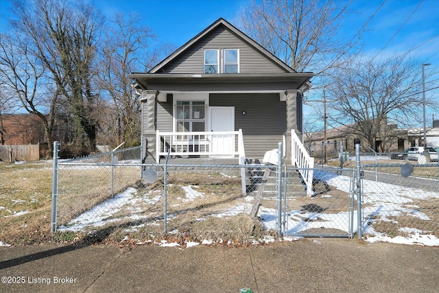 view of front of property with a fenced front yard, covered porch, and a gate