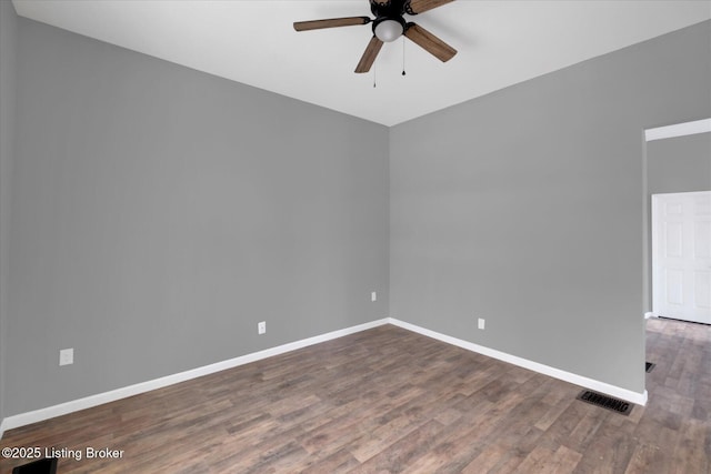 unfurnished room with visible vents, baseboards, ceiling fan, and wood finished floors