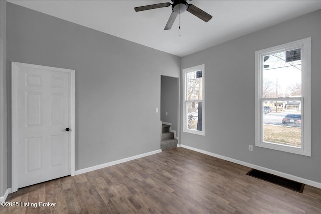 unfurnished room with stairs, visible vents, and a wealth of natural light