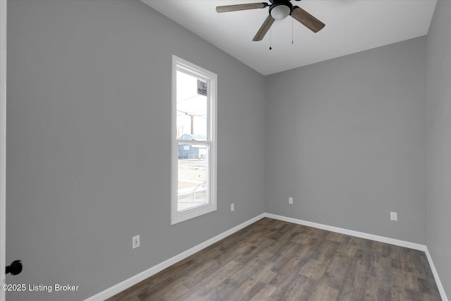 spare room with plenty of natural light, a ceiling fan, and baseboards