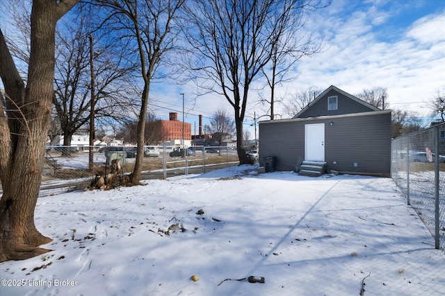 yard covered in snow with entry steps and fence