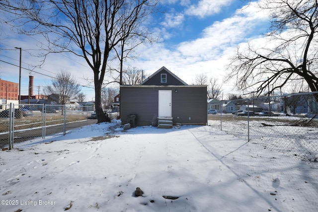 snow covered property featuring entry steps and fence