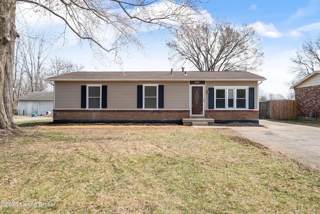 single story home with a front lawn, fence, and brick siding