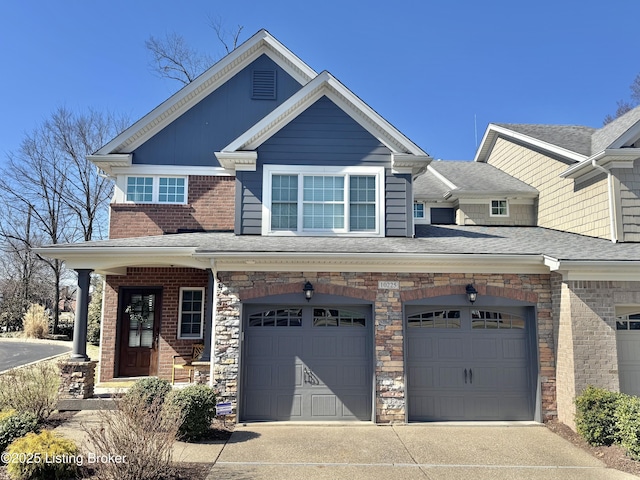 view of front facade with concrete driveway, brick siding, and a shingled roof