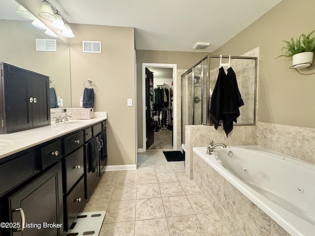 full bathroom featuring tile patterned floors, visible vents, a jetted tub, and a shower stall