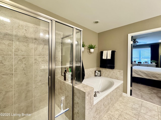 full bathroom featuring a garden tub, a ceiling fan, ensuite bath, a shower stall, and tile patterned flooring