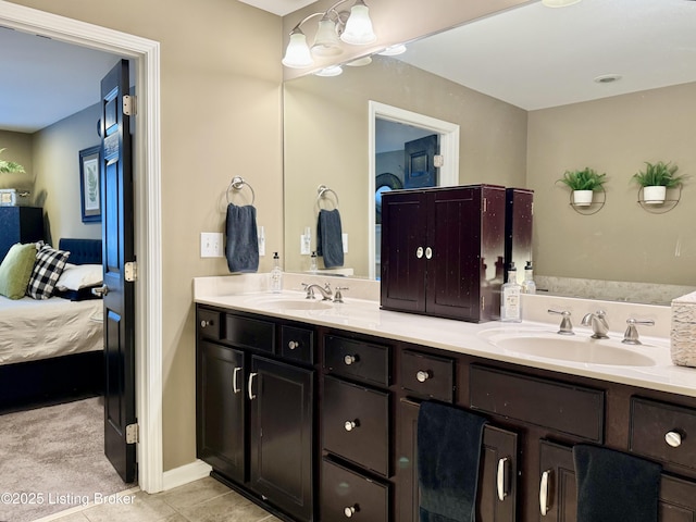 ensuite bathroom featuring a sink, double vanity, ensuite bathroom, and tile patterned floors