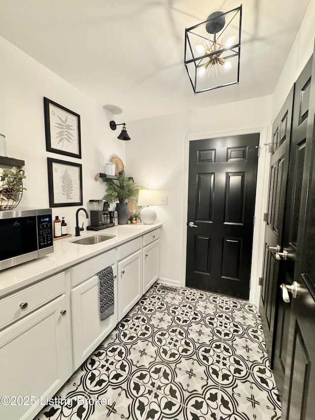 interior space with tile patterned floors, a chandelier, and vanity