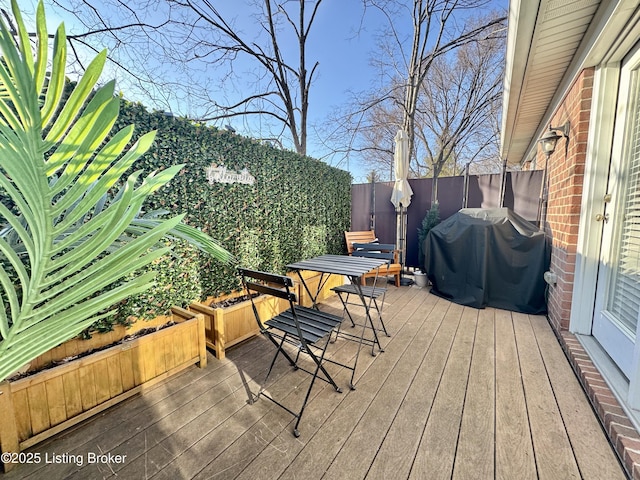 wooden terrace with a grill