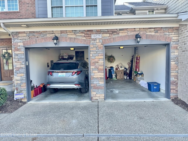 garage featuring concrete driveway