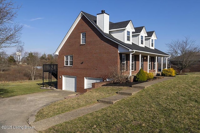 view of side of home featuring brick siding, a yard, concrete driveway, and a garage