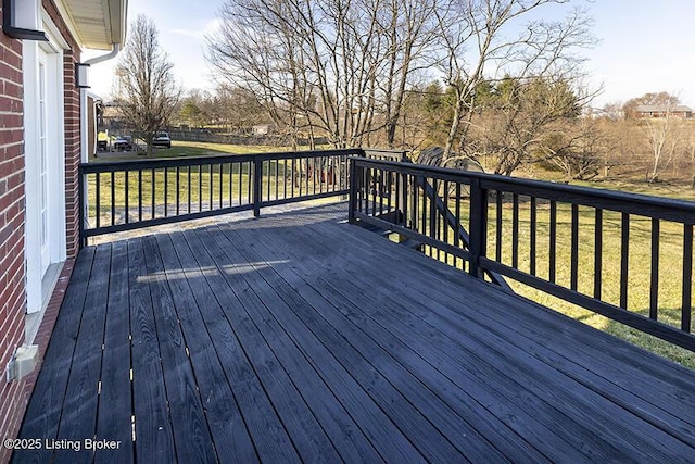 wooden terrace with a yard