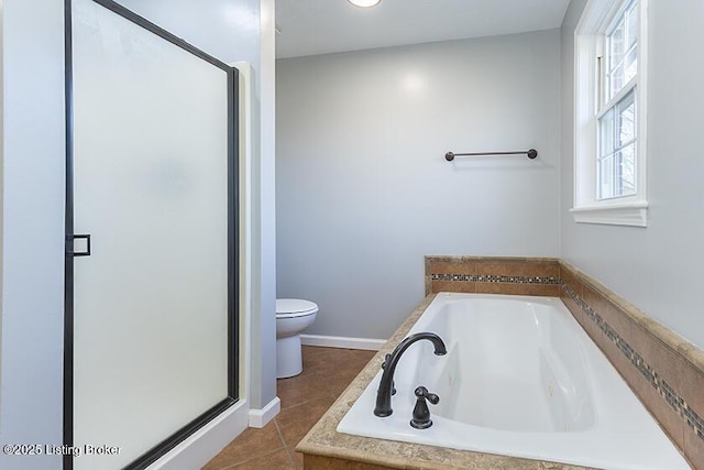 bathroom featuring a shower stall, a jetted tub, baseboards, toilet, and tile patterned floors