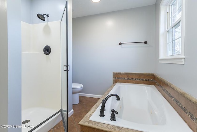 full bathroom featuring tile patterned floors, a garden tub, a shower stall, and toilet