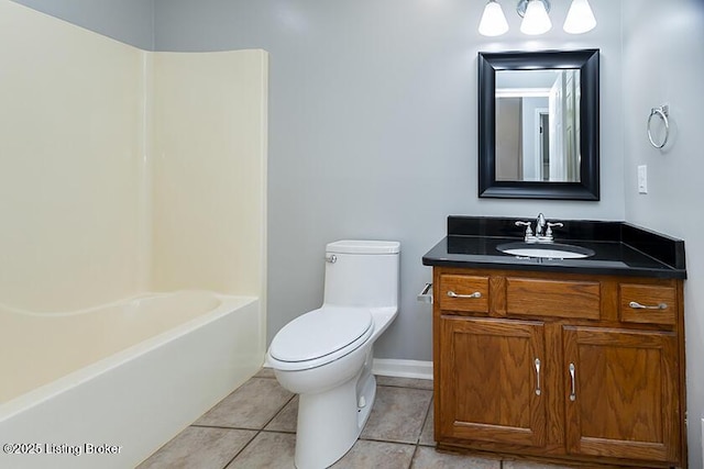 bathroom with tile patterned flooring, toilet, vanity, and baseboards