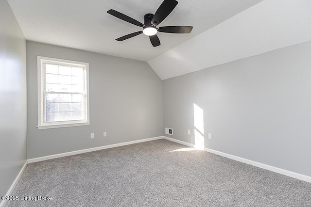 bonus room featuring baseboards, ceiling fan, carpet flooring, and vaulted ceiling