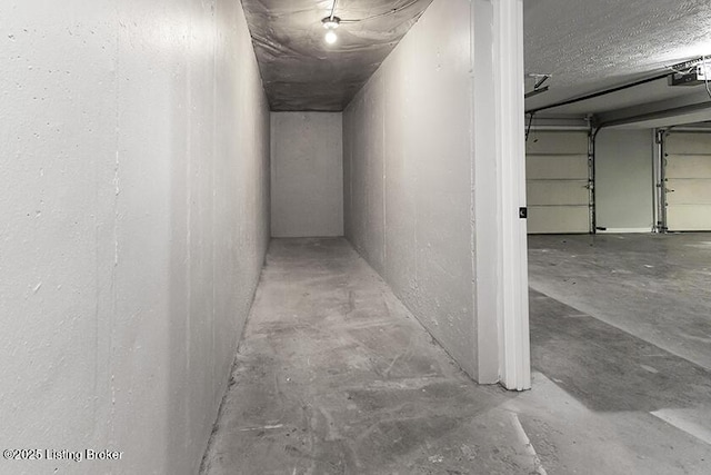 hallway with unfinished concrete flooring