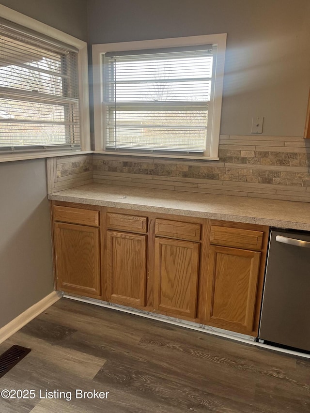 kitchen with dark wood finished floors, visible vents, dishwasher, and light countertops