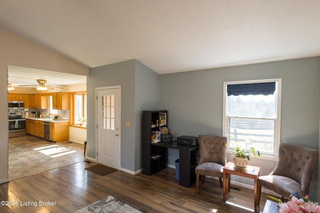 living room with dark wood-style floors, ceiling fan, baseboards, and vaulted ceiling