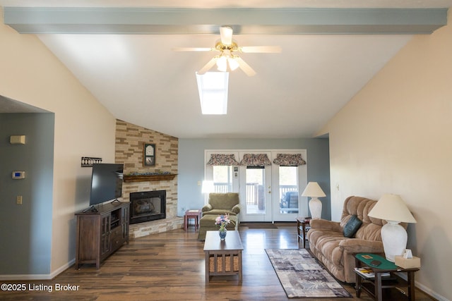 living area featuring a stone fireplace, vaulted ceiling with beams, dark wood-type flooring, and baseboards