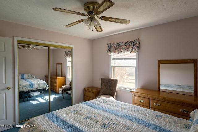 carpeted bedroom featuring a textured ceiling, a closet, and ceiling fan