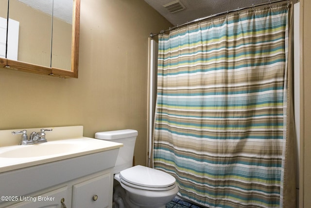 bathroom featuring vanity, a shower with curtain, visible vents, a textured ceiling, and toilet