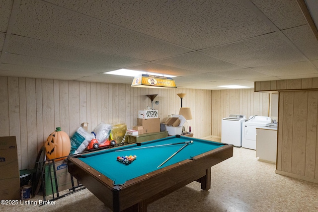 game room featuring a drop ceiling, washing machine and dryer, billiards, and wood walls