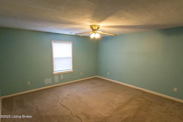 spare room featuring baseboards, carpet flooring, a textured ceiling, and ceiling fan