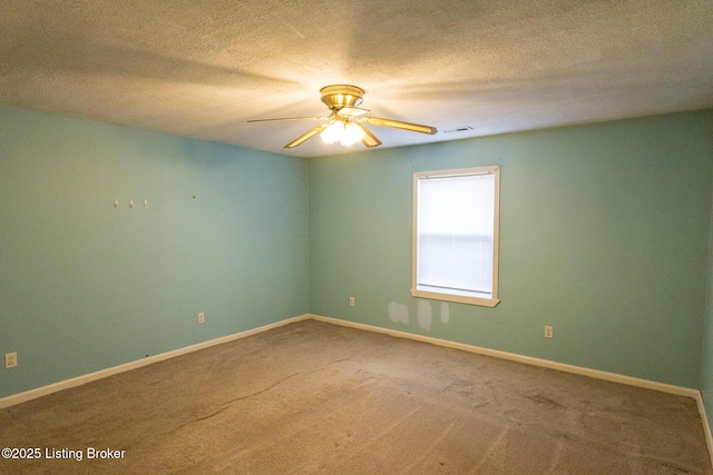 empty room featuring visible vents, a ceiling fan, a textured ceiling, carpet floors, and baseboards