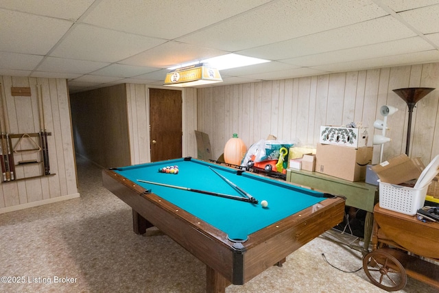 playroom with wood walls and a drop ceiling