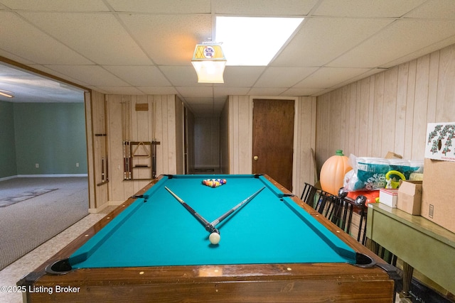 playroom featuring a paneled ceiling, wooden walls, pool table, and carpet flooring