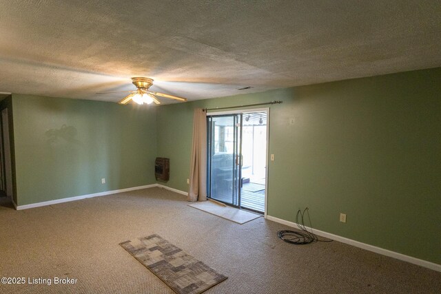 spare room featuring heating unit, baseboards, ceiling fan, a textured ceiling, and light colored carpet