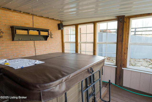 sunroom / solarium with a hot tub