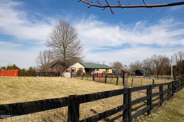 view of yard with an enclosed area and a rural view