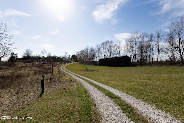 view of road featuring an outbuilding and a rural view