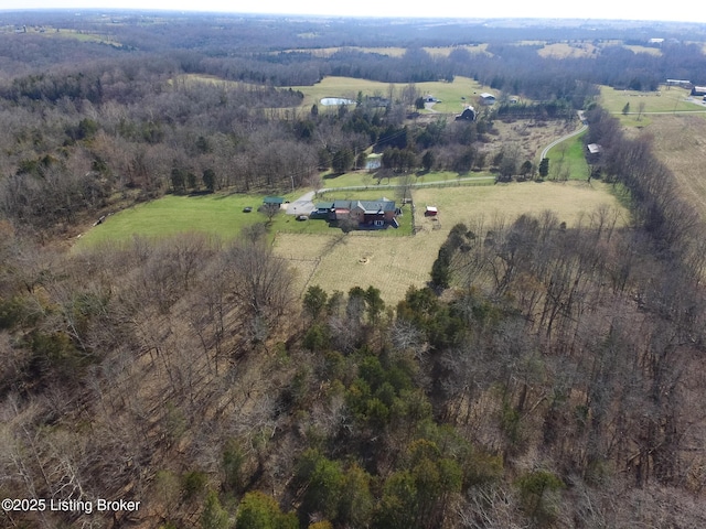 drone / aerial view with a view of trees and a rural view