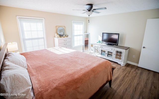 bedroom featuring a textured ceiling, a ceiling fan, baseboards, and wood finished floors