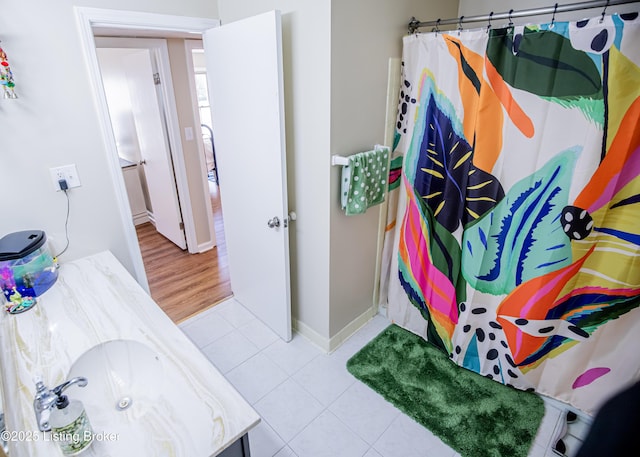 full bathroom featuring baseboards, a shower with curtain, and tile patterned flooring