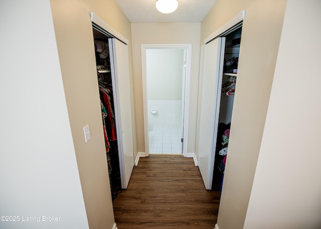 hallway featuring dark wood-style flooring