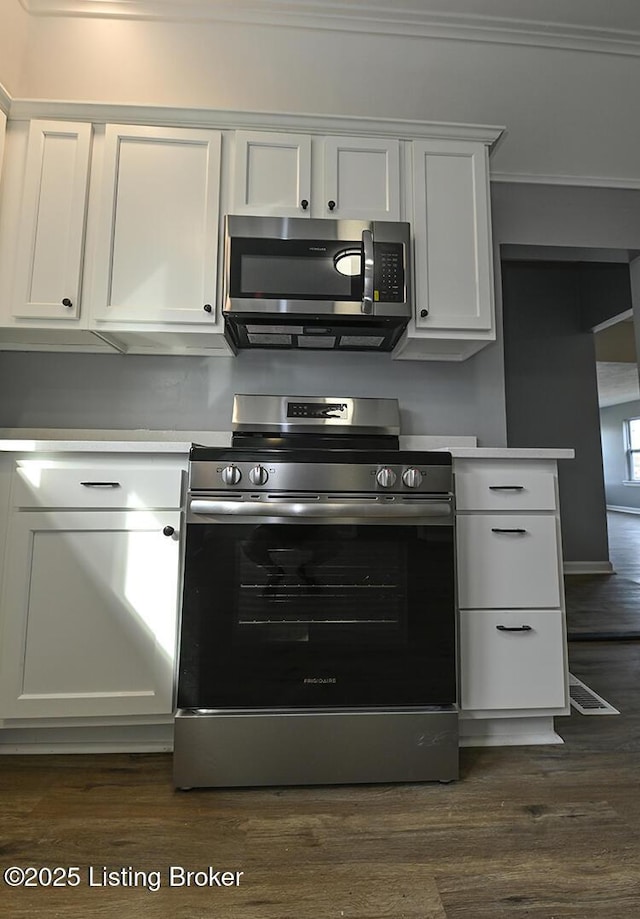 kitchen featuring dark wood-style floors, white cabinetry, and stainless steel appliances