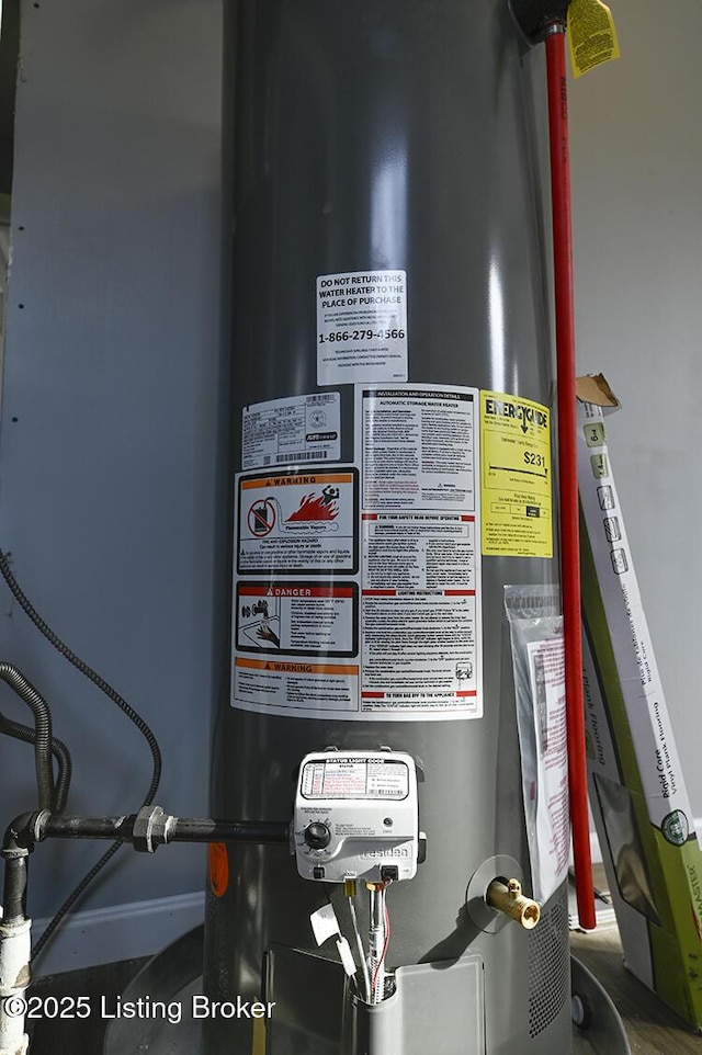 utility room featuring water heater