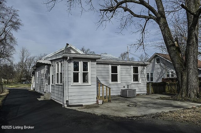 back of house featuring entry steps, a patio area, central AC unit, and fence